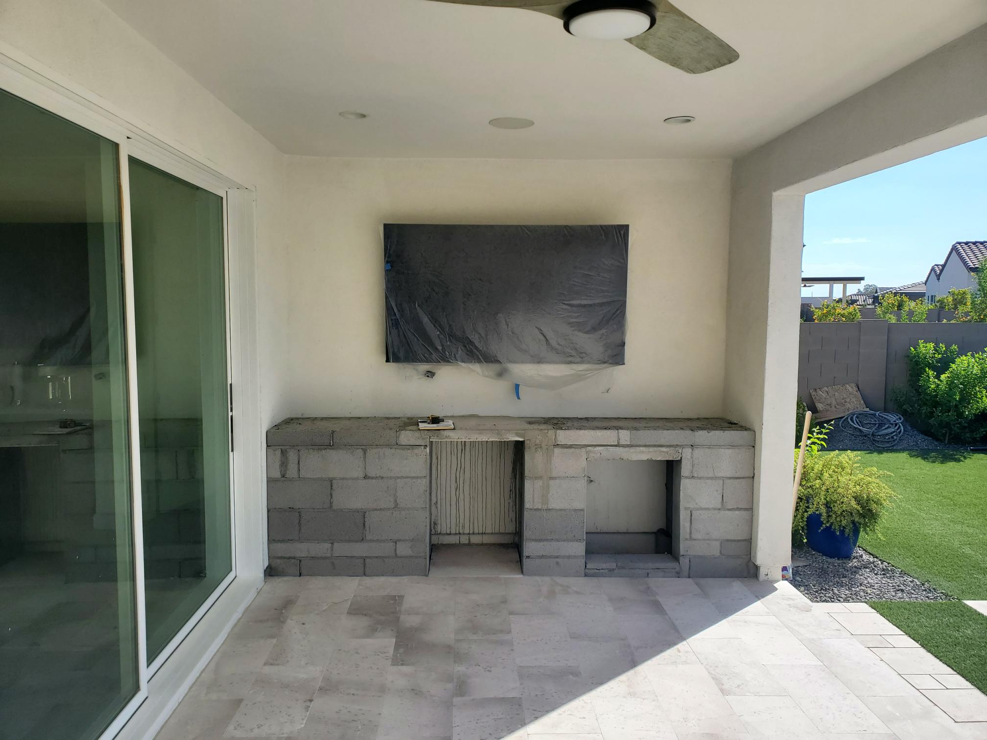 Outdoor entertainment: An exterior television installation during construction.